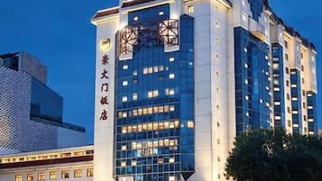 A multi-story hotel building with a prominent entrance and a modern architectural design.