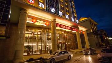 A hotel with a prominent entrance, large windows, and a visible sign.