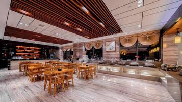 A modern interior with a marble floor, wooden furniture, and a central bar area.
