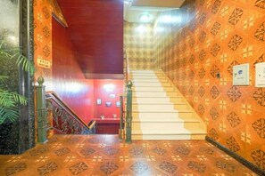 A staircase with patterned walls and a handrail, leading to a lower level. - Ping'an Business Hotel (Harbin)
