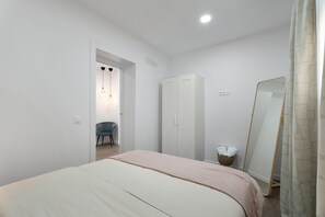 A bedroom with a bed, wardrobe, chair, and a mirror. - Holiday Home 'Llano Del Rey' with Sea View, Private Pool & Complete Tranquility (Arona)