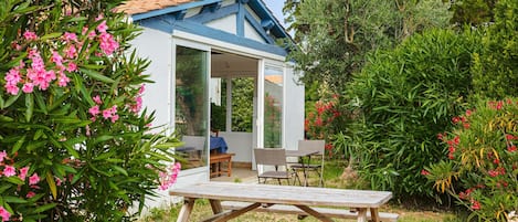 A house with a patio, a dining table, and chairs.