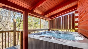A hot tub in a wooden deck area with a view of trees. - Unwind in the Hot Tub with Calming Treetop Vistas, Play Arcade Games & Sip Fireside - Wanderlust (Sevierville)