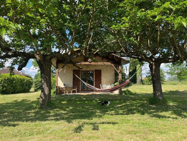 Relax in a serene outdoor space with a gazebo, hammock, and lush lawn.
