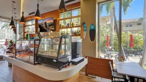 A cafe with a counter, display case, and seating area.