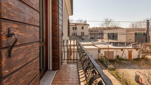 A balcony with a wooden door, a metal railing, and a view of neighboring buildings. - GuestHost - Wonderful apartment of about 80 square meters, able to accommodate 5 people, located on the first floor of a villa without a lift (with internal and external steps).The property is located in the heart of Venice Mestre, in a quiet and well-se (Venice)