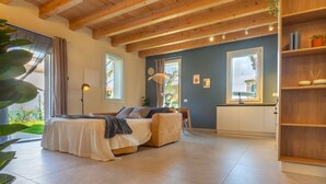 A bedroom with a bed, a bedside table, a lamp, a window, and a view of the outside. - GuestHost - Oasis of the Knight! (Ferrara)