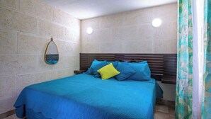 A bedroom with a bed, a mirror, and a window with curtains. - Poolside Stay w/ Private Patio Near the Beach (Oistins)