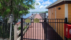 Una pasarela de madera que lleva a un edificio con vistas al agua.