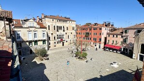 A spacious public square with historic buildings, a flagpole, and a few people. - Salieri Attic (500mt. from St. Mark's Square) (Venecia)