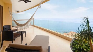 Relax on your ocean-view balcony with hammock & lounge chairs at Garza Blanca.