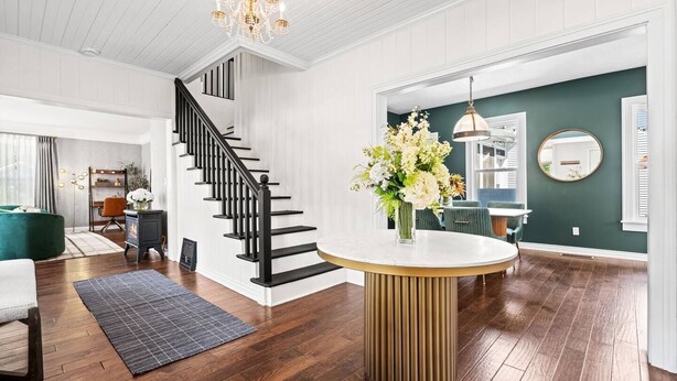 A modern interior with a staircase, a dining area, and a living space. - Renovated 1871 Chestnut House | Hot Tub & Fire Pit (Douglas)