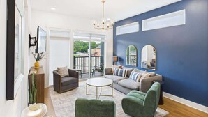 A modern living room with a sofa, armchairs, a coffee table, and a chandelier. - Gallatin Retreat-Rooftop- Full Gym -East Nashville (Nashville)
