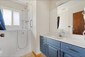 Un baño con ducha, inodoro y lavabo.