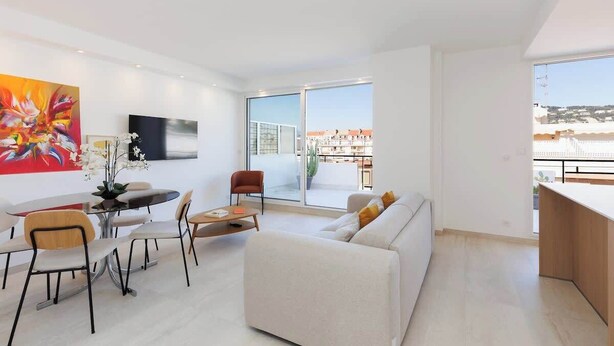 A modern living room with a sofa, dining table, chairs, a TV, and a large window with a view.