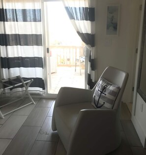 Exclusive Studio, 1 Queen Bed, Patio, Pool View | Living area | 50-inch Smart TV with digital channels