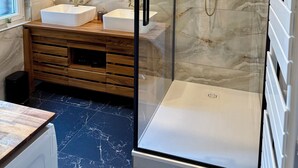 A modern bathroom with a glass-enclosed shower, two sinks, a large mirror, and marble walls. - THE REMOISED ECRIN (Reims)