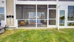 A house with a covered patio area featuring a sofa and a table. - Pet Friendly, Includes Pool, Kids' Pool, & Free* Golf & Activities, 10 Mins to Beach, 1st Fl. (Ocean View)