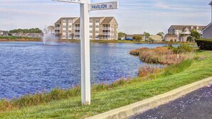 A street sign at a water's edge with "Pavillion Dr" on both sides. - Pet Friendly, Includes Pool, Kids' Pool, & Free* Golf & Activities, 10 Mins to Beach, 1st Fl. (Ocean View)