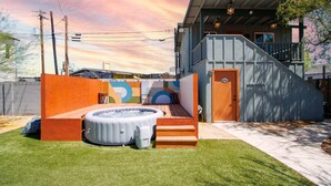 A modern house with a hot tub, a wooden deck, and a staircase leading to a balcony. - Stylish "NEW" Home- Hot Tub - Near Downtown, PHX Airport, and ASU (Phoenix)