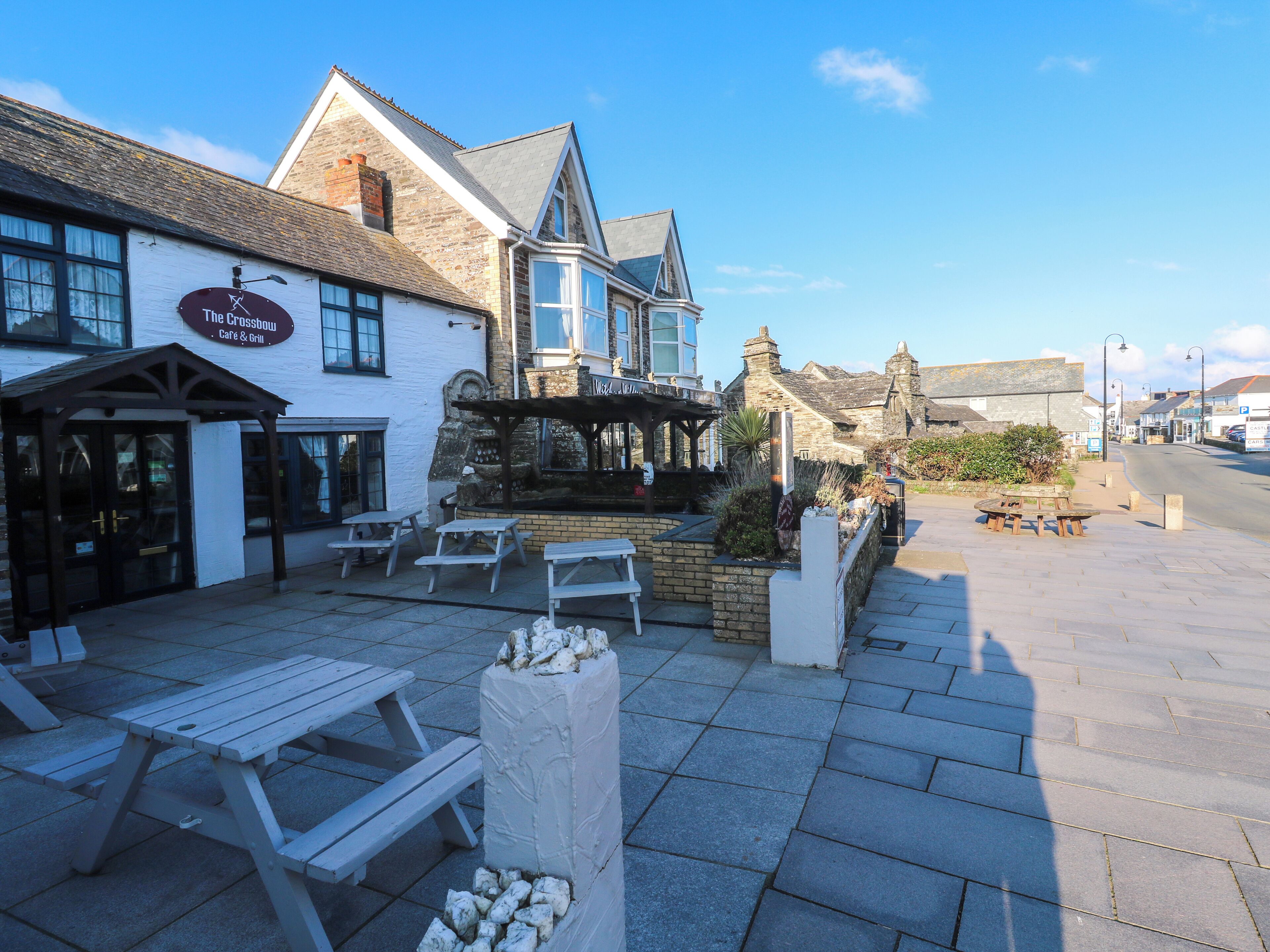A traditional pub with outdoor seating and a stone facade.