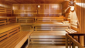 A wooden sauna with benches arranged in rows.
