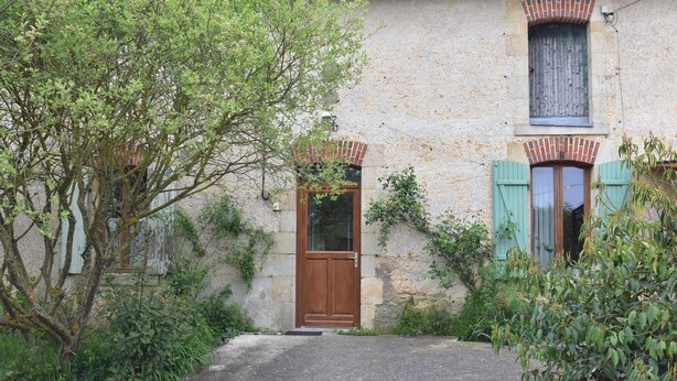 A rustic building with a wooden door, a window with shutters, and a brick archway. - Farmhouse in Giroux near Forest & Lake (Giroux)