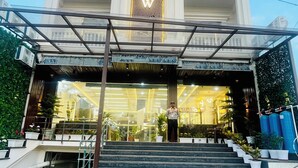 A hotel entrance with a grand facade, a central sign, and a covered entrance area. - The Castle View (Haridwar)