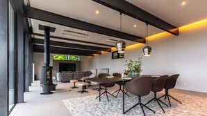 A modern living room with a fireplace, dining area, and seating. - KISIN (Yoichi)