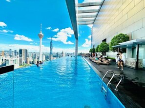 A rooftop infinity pool with a city skyline view, including a prominent tower. - WELL-SHAPED Suites At PLATINUM KLCC (Kuala Lumpur)
