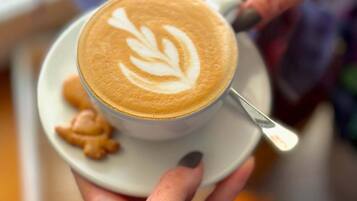 A cup of coffee with latte art on a saucer.