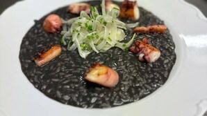 A plate of black risotto with garnishes. - Penzion Tlustá kachna  (Chrudim)