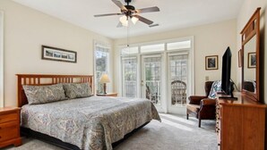 A bedroom with a bed, a ceiling fan, a dresser, a chair, and a television. - Mountain View Fore You - Golf Front 2 BR, 2BA Condo (Maggie Valley)