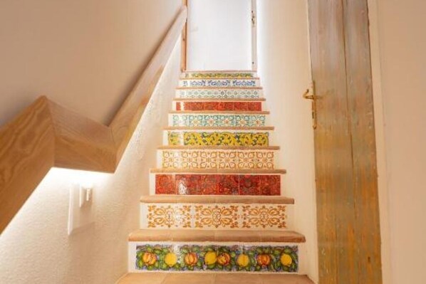 Un escalier orné d’un carrelage coloré aux motifs variés.