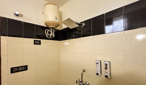 A bathroom with a toilet, a hand dryer, and a towel dispenser. - Winterline Gold Resort (Lansdowne)