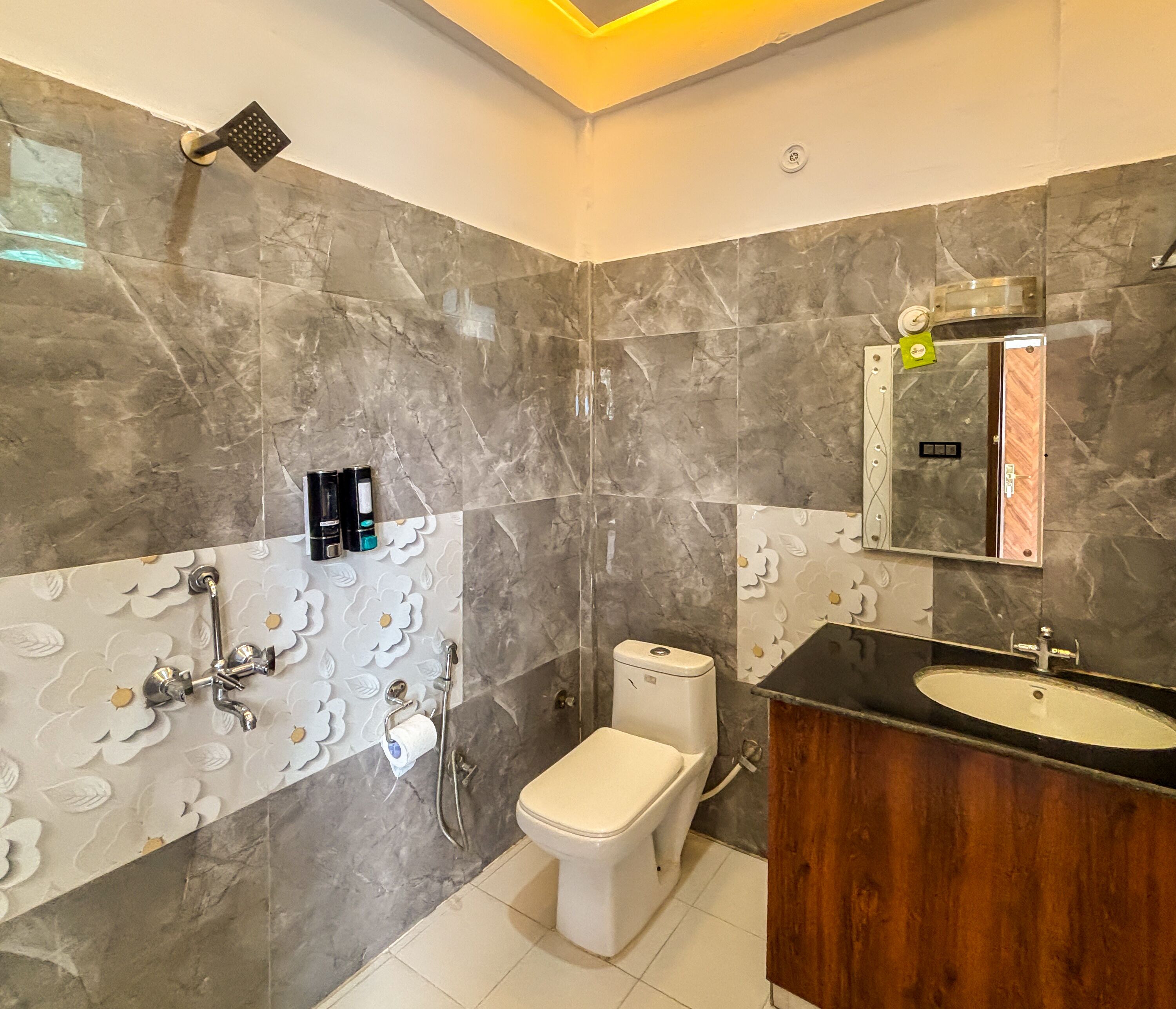 A modern bathroom with a toilet, shower, and sink.