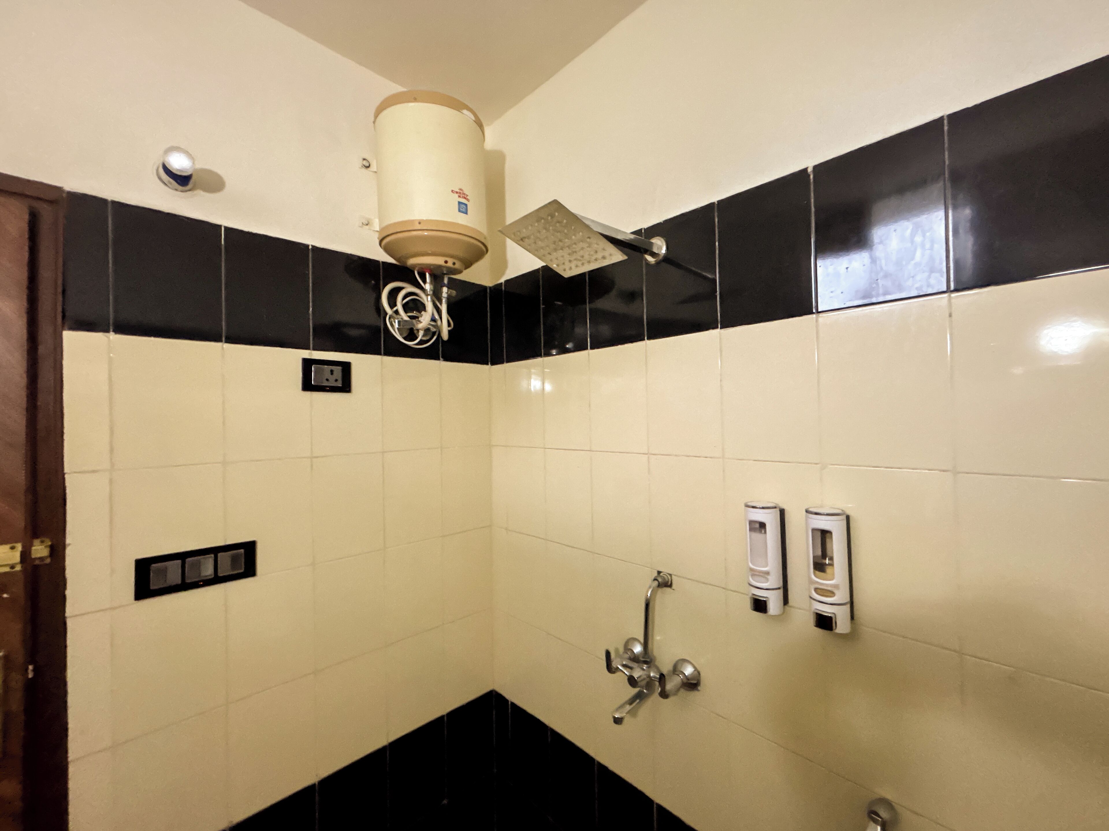 A bathroom with a toilet, bidet, and hand dryer.