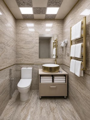 A modern bathroom with a toilet, sink, and shower. - Central City Department Hotel (Baku)
