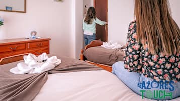 A bedroom with a bed, a dresser, and a mirror.
