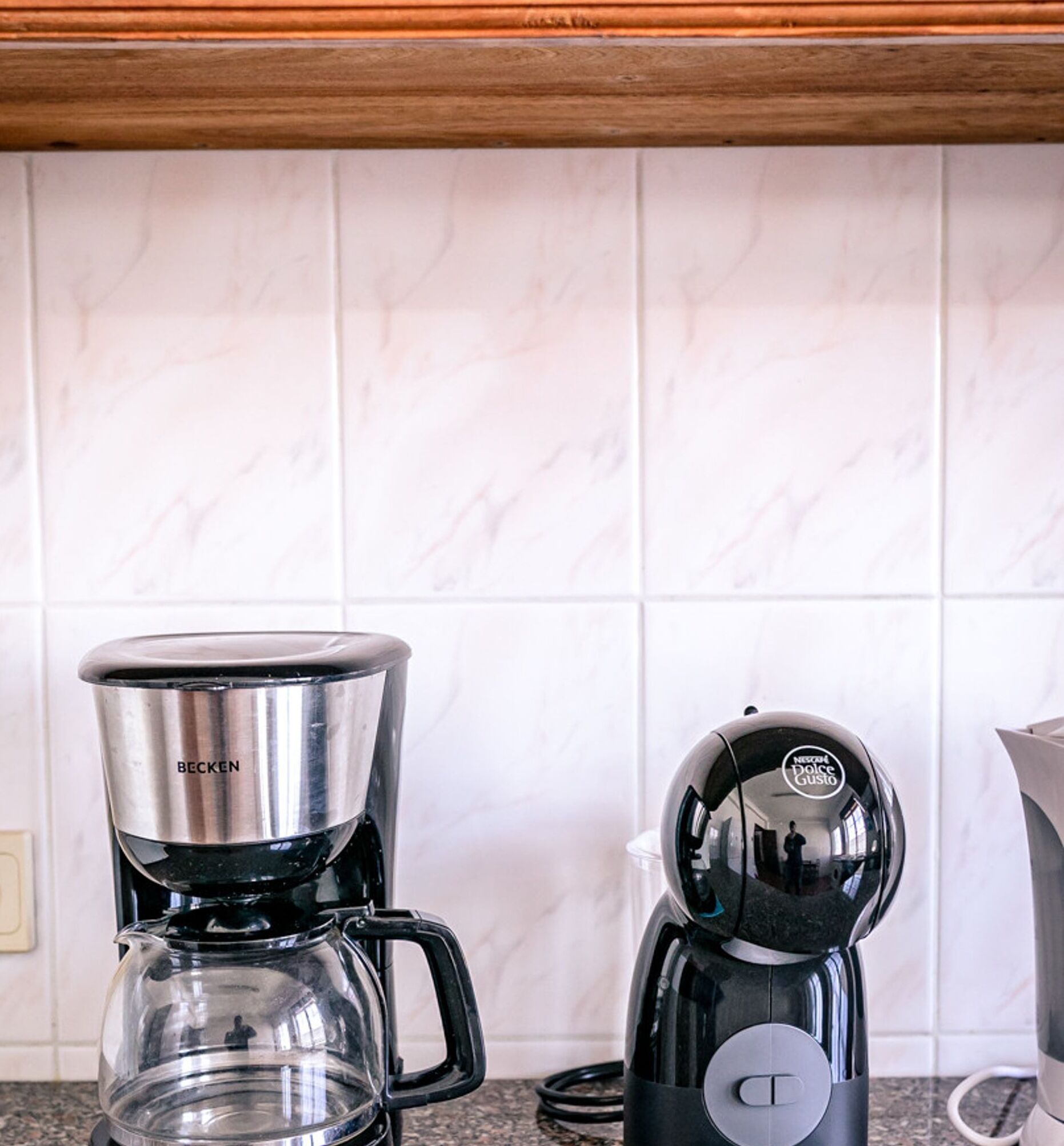 A kitchen with a coffee maker and a water dispenser.