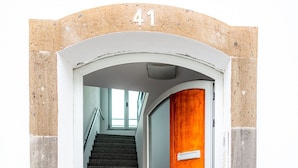 A staircase leading to a room with a wooden door, a number '41' above the door, and a window at the top of the stairs. - Olis House in Angra do Hero smo (Angra do Heroismo)
