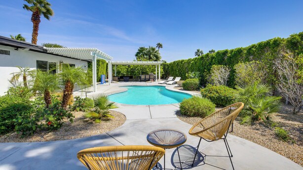 A modern outdoor pool area with a pergola, lounge chairs, and a well-maintained garden. - Mtn Views & Outdoor Oasis: Palm Springs Getaway (Palm Springs)
