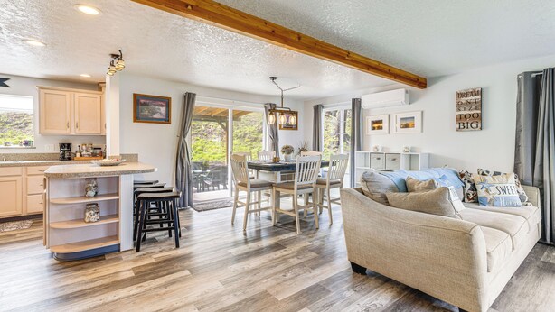 A spacious living area with a kitchen, dining table, and a sofa. - 3 Mi to Beach: Oregon North Coast Retreat (Warrenton)