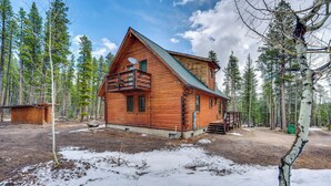 A log cabin with a balcony, surrounded by a forest. - 4 Mi to Rmnp: Allenspark Cabin w/ Wraparound Deck! (Allenspark)