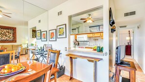 A modern kitchen with a microwave, sink, and wooden counter. There are framed pictures on the wall and a ceiling fan above. - Close to Golf: Mtn-view Townhome in Green Valley (Green Valley)