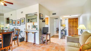 A spacious living area with a dining table, chairs, a sofa, and a television. - Close to Golf: Mtn-view Townhome in Green Valley (Green Valley)