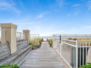 A wooden boardwalk leading to a beach with white railings and a clear sky. - Emerald Key #602 | 3BD/2BA, Pool, Beach Access, Across from Shopping Center (Orange Beach)