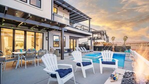 A modern outdoor patio with a pool, lounge chairs, and a barbecue area. - 52-53 | Family reunion home! 2 pools, 2 hot tubs (Santa Clara)