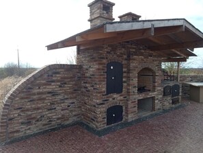 A brick structure with a chimney, a covered area, and a brick-paved ground. - Luxury home: sauna, Turkish bath, jacuzzi, hot tub, fireplace - Polish Baltic Sea (Pogorzelica)