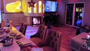 A modern living room with a fireplace, a television, and comfortable seating. - Luxury house: sauna, turk. Steam bath, Jacuzzi, whirlpool, fireplace - Polish Baltic Sea (Pogorzelica)